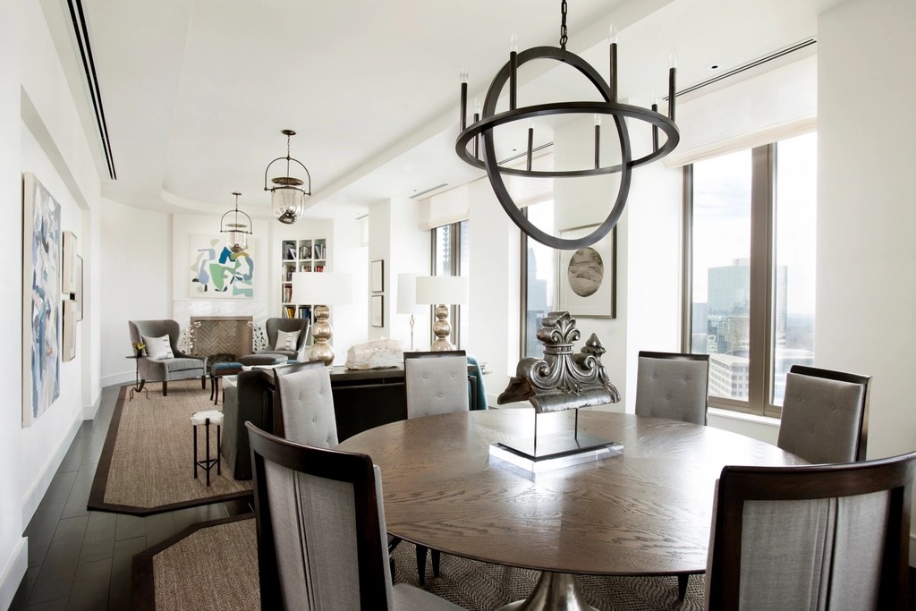 Living and dining space with floor-to-ceiling glazing and a city view