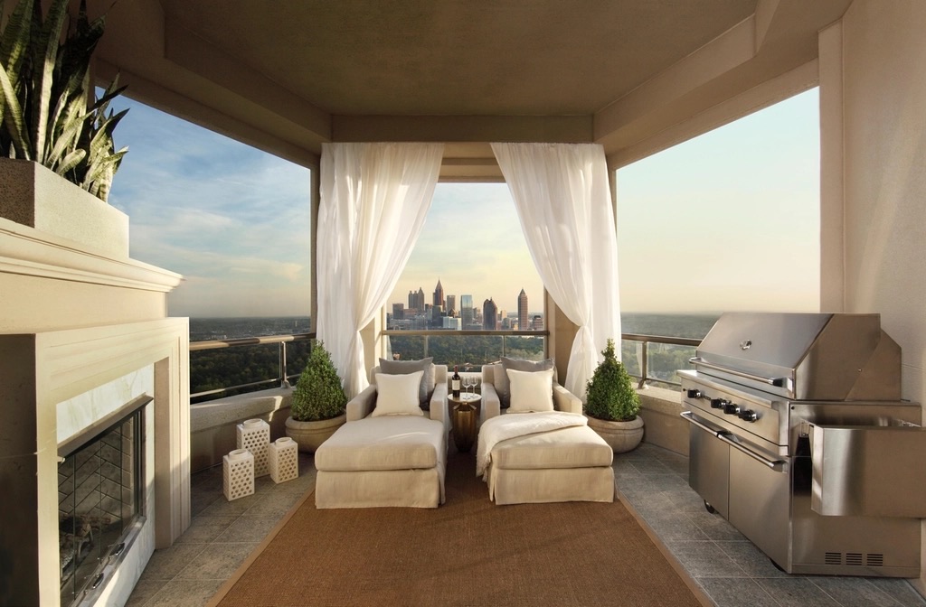 Covered private terrace at dusk, looking out over the city skyline